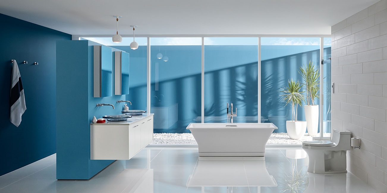 Blue master bathroom with Kohler finishes and large bathtub
