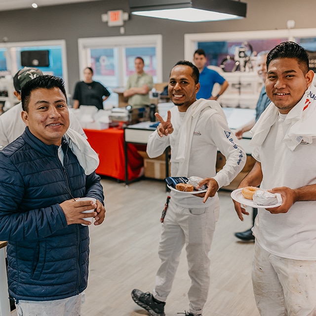 Three Benjamin Moore painting contractors posing and smiling in a locally owned Benjamin Moore store. Three Benjamin Moore painting contractors posing and smiling in a locally owned Benjamin Moore store.