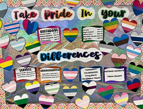 A Take Pride in Your Differences Board features Benjamin Moore employee birthdays, anniversaries, and colorful striped hearts.