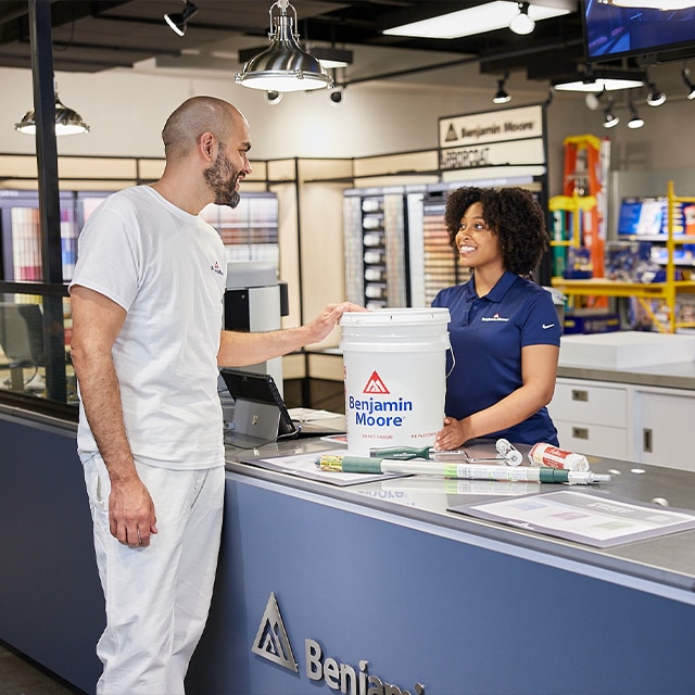 A Benjamin Moore store professional sells paint and supplies to a painting contractor.