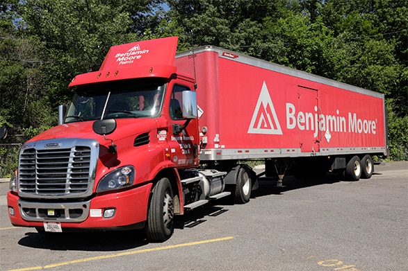 A large, red Benjamin Moore delivery truck.
