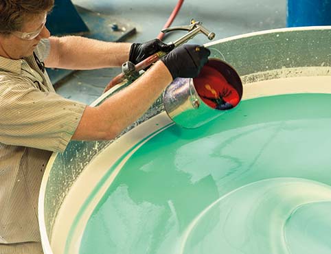 A Benjamin Moore employee mixes a vat of paint.