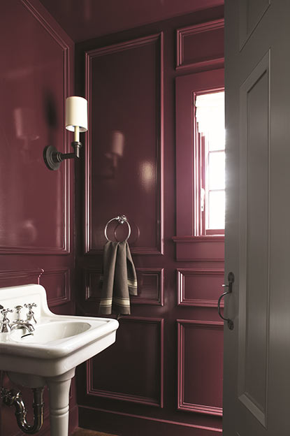 Bathroom walls painted in deep purple paint color in high gloss finish.