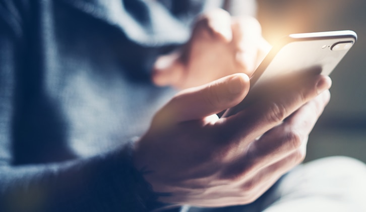 A close-up of a person holding a smartphone.