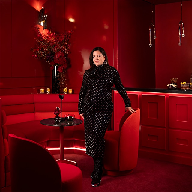 Interior designer Sasha Bikoff poses in the Benjamin Moore red-painted lounge in Madison Square Garden. 